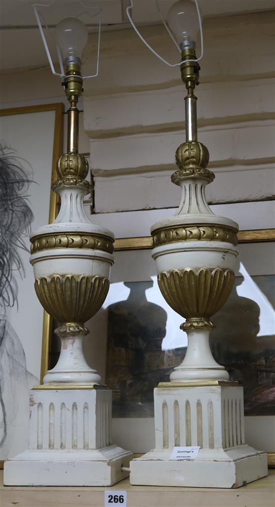 A pair of cream and gilt carved wood table lamps, on square bases